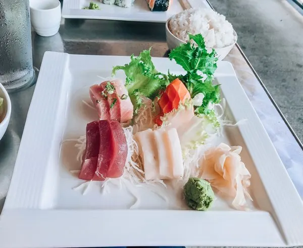 Zen Sushi Asheville North Carolina with pink, orange and white sushi fish on rice on top of white plate