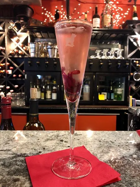 Battery Park Book Exchange Literary Cocktail in a champagne flute on a bar counter