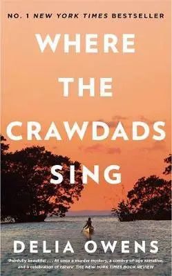 Where The Crawdads Sing by Delia Owens book cover with orange sky and shadow of woman canoeing in the marsh