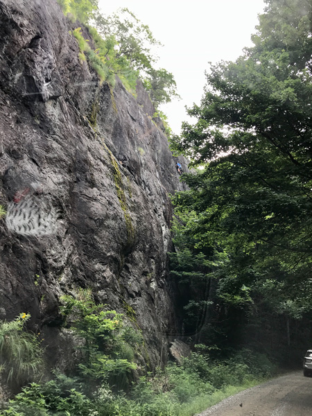 FS74 Road Douglas Falls NC dirt road with one other car and big rock side with someone climbing up