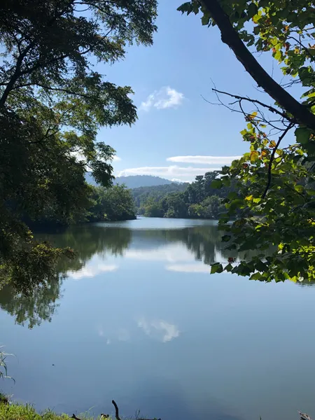 Beaver Lake Perimeter Trail and Bird Sanctuary Asheville North Carolina lake with trees and Blue Ridge Mountains
