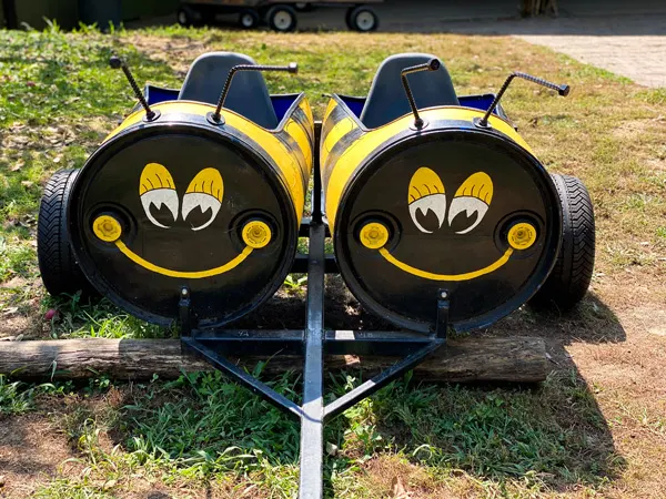 Sky top orchard bee train with two barrels that look like bees