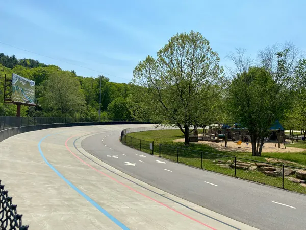 Carrier Park Asheville NC with velodrome with paved lanes for walking and bike riding with trees and recreation area in the middle