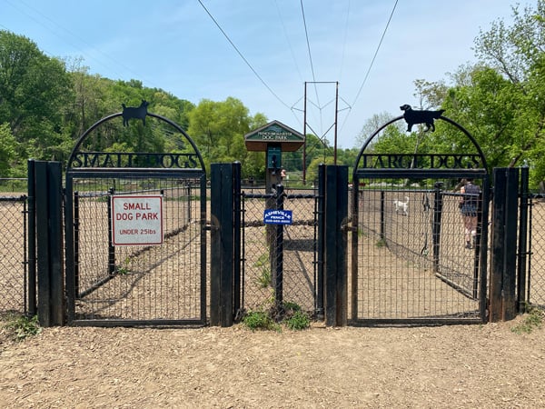 French Broad River Dog Park in Asheville NC with split fenced area with signs for one side with big dogs and one for small dogs
