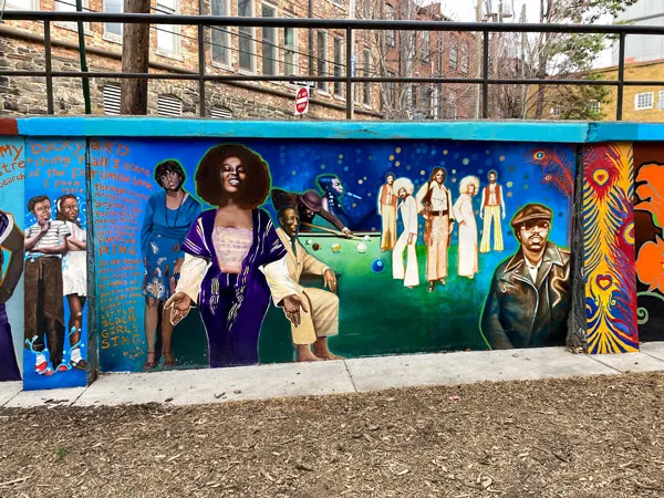 Triangle Park Asheville Murals with Black women in dresses and group of people in 70s clothingf 