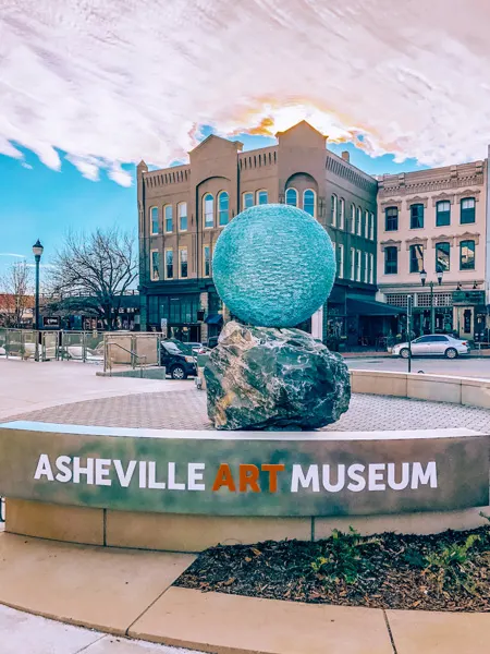 Asheville Art Museum with blue ball statue out front