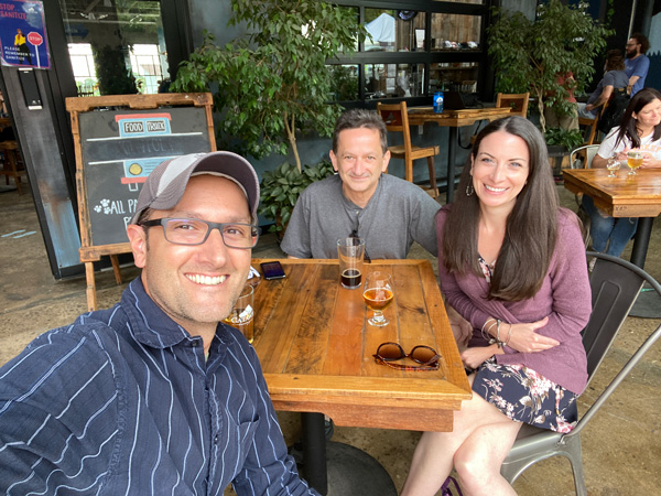 Catawba Brewing Co. Downtown Asheville NC with two white brunette men and one female drinking beer at table