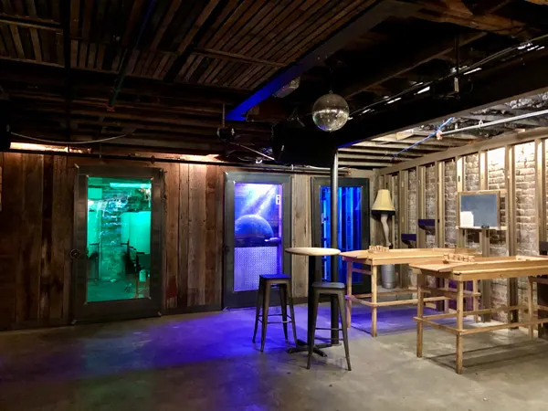 Downtown Asheville Breweries One World Brewing darker taproom with green and purple lights