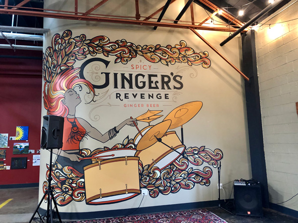 Gingers Revenge Asheville NC with mural of woman playing the drums