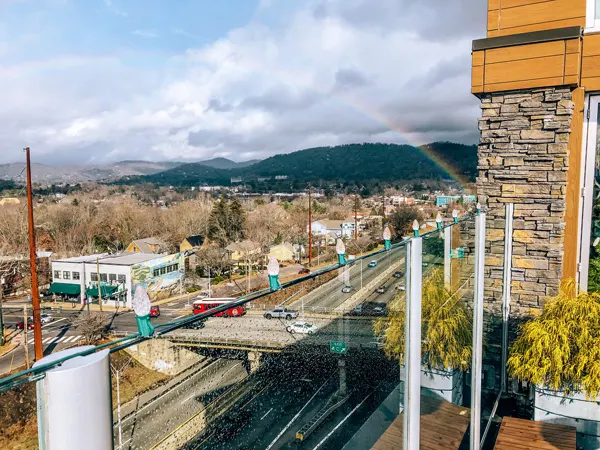 The Montford Rooftop Bar Asheville NC with rainbow and view off balcony