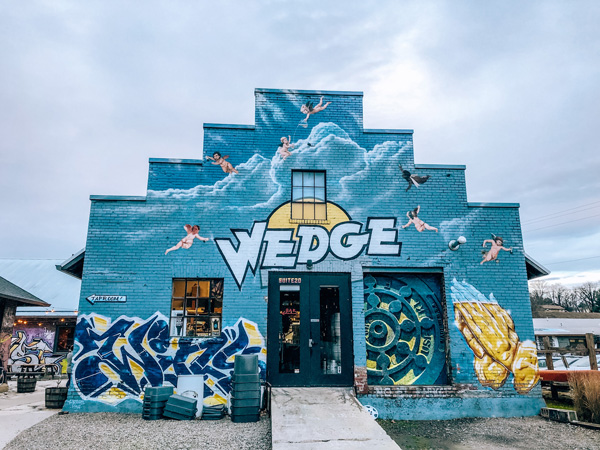 Wedge Brewing At Foundation in River Arts District Asheville NC blue building covered with street art