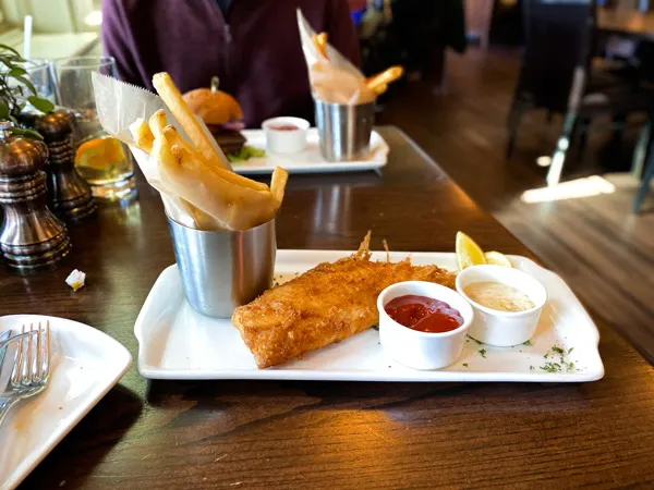 Cedric's Tavern Asheville at Biltmore Estate with fish and chips and fries with sauces on white plate