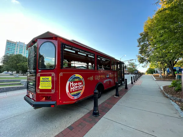 Gray Line Trolley Tours Asheville North Carolina with red hop on and off trolley car parked in Pack Square