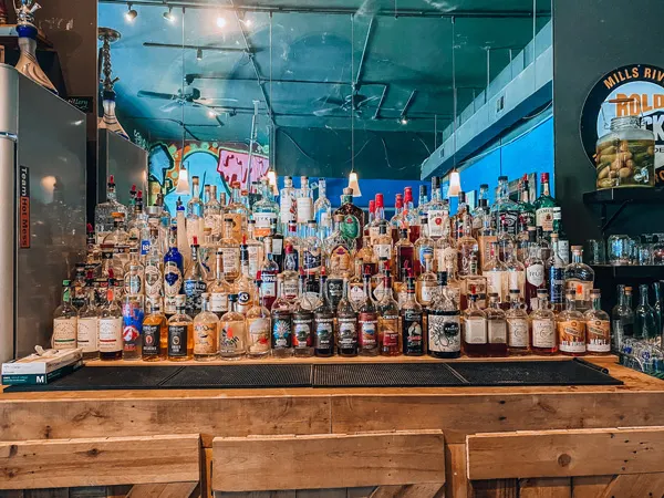 Adam Dalton Distillery Bar Asheville with alcohol lined up and mirror