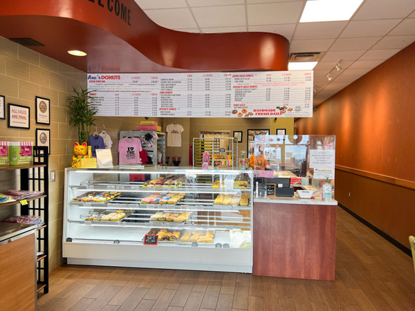 Avas Donuts Asheville NC Cafe with display of donuts in glass case, menu above ordering area, and cashier station