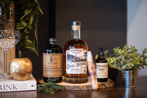 Distilleries in Asheville Cultivated Cocktails with bottle of whiskey, bitters, sugar, and cocktail ingredients