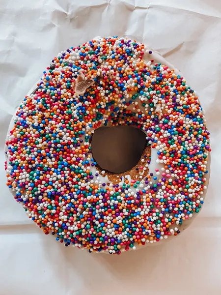 Geraldines Bakery Asheville donuts with vanilla donut and glaze with rainbow sprinkles