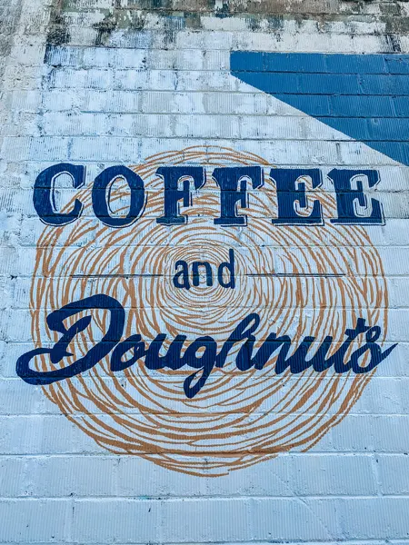 Vortex Doughnuts Asheville with blue and gold-ish brown coffee and doughnuts mural on side of building
