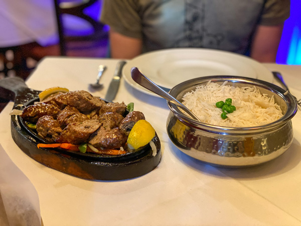 Andaaz Fine Dining Indian Restaurant Asheville NC with sizzling skillet of beef and peppers