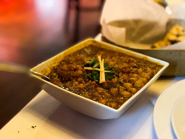 Andaaz Indian Food Asheville with bowl full of spicy lentils and garnish