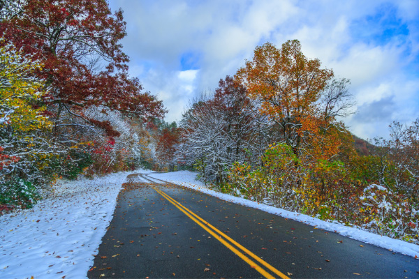 Blue Ridge Parkway Winter Road with snow and fall foliage trees