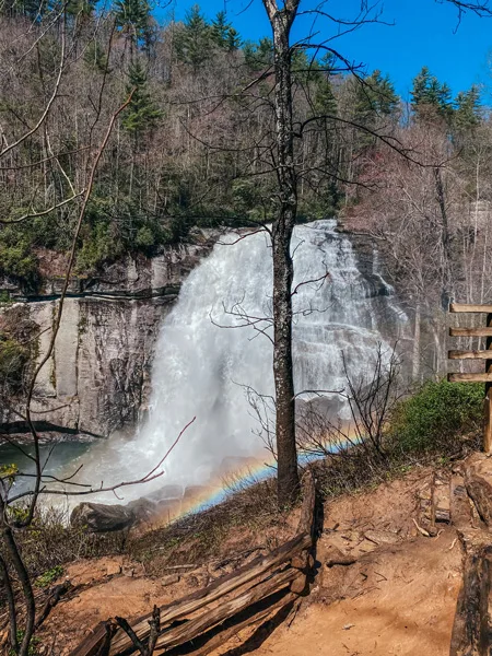 Rainbow Falls NC with rainbow over waterfalls and dirt trail