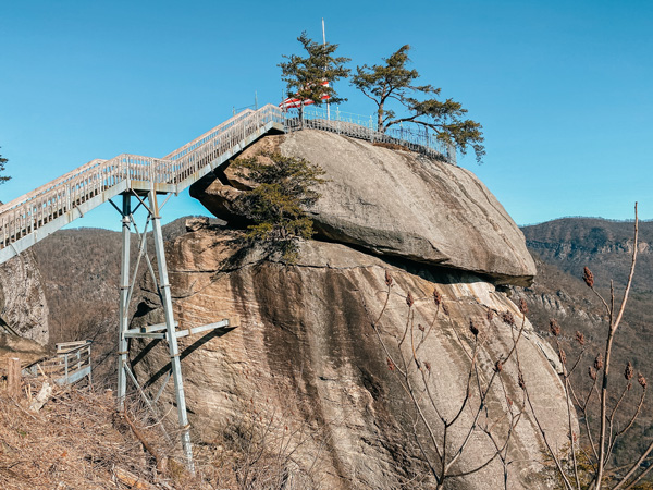 Chimney Rock At Chimney Rock State Park with tiered rocks with staircase and American flag