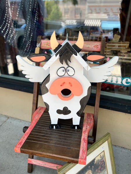 Downtown Hendersonville NC Cow bird house with wings and hole where cow's mouth is