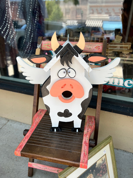 Downtown Hendersonville NC Cow bird house with wings and hole where cow's mouth is