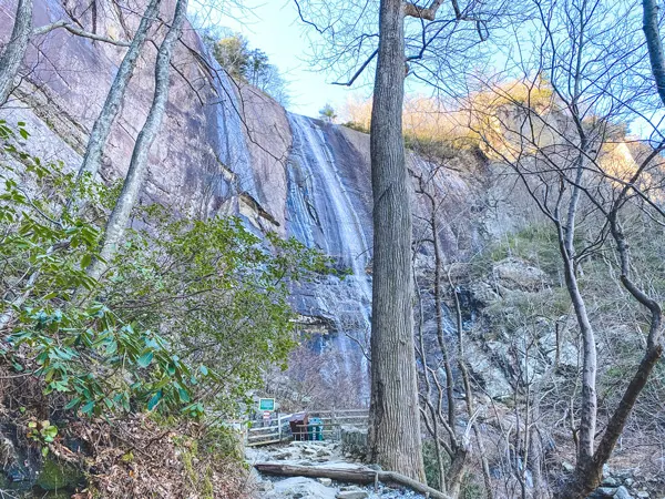 Hickory Nut Falls Chimney Rock with somewhat frozen waterfall along the rocks in forest