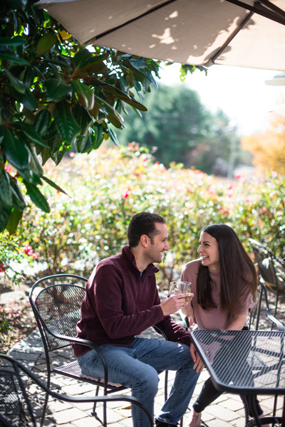 Picnic Near Asheville Burntshirt Vineyards with brunette white male and female sitting at a table with wine