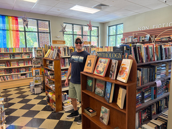 Tom between bookshelves at As The Page Turns