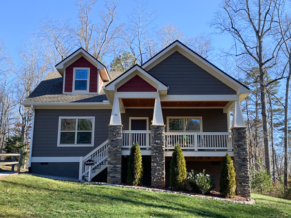 Asheville Cottages in Asheville NC with picture of 2-bedroom gray and red cottage with white trim and green grass