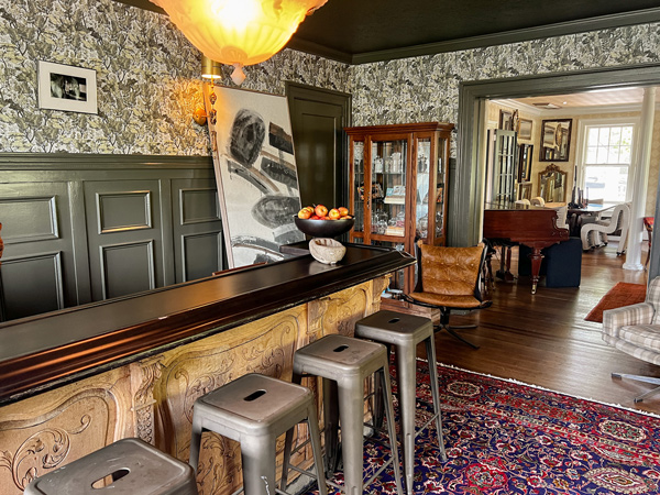 Blind Tiger Asheville NC Hotel Breakfast Bar with bar stools up against bar and green patterned wallpaper