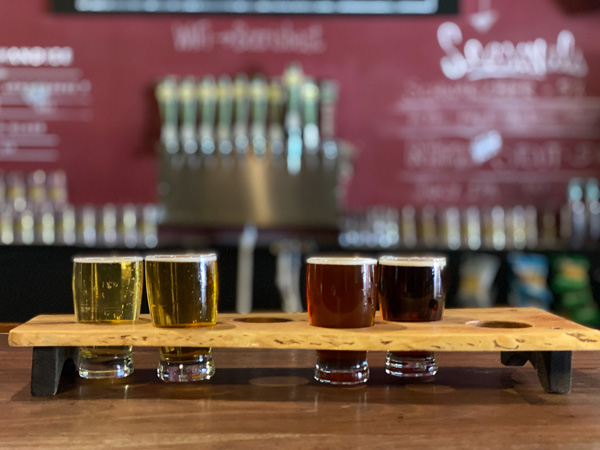 Brevard Brewing Company with flight of lagers and pilsners at bar in taproom