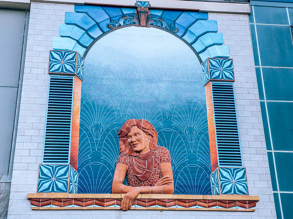 Daydreamer Aloft Mural Asheville Alex Irvine and Ian Wilkinson  woman leaning out of a window and daydreaming made from tiles and ceramics