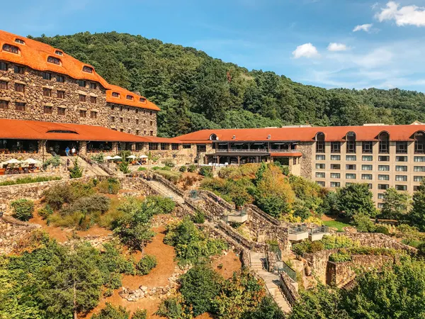 resorts in Asheville Omni Grove Park Inn with orange roof and stone facade along with terraces and stairs