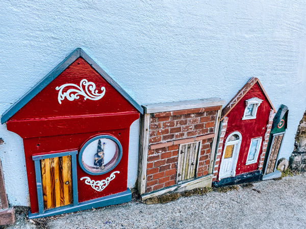 Small houses artwork Asheville with tiny painted and sculpted red and brick houses on Woodfin St. in downtown Asheville