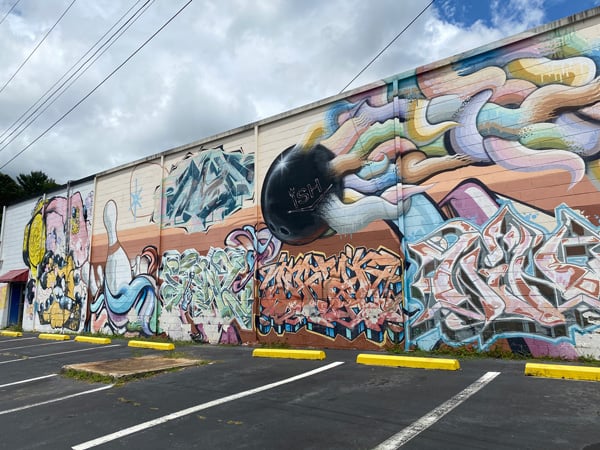 The Big Lebowski Burners and Barbecue Mural Project with street art filled with tags, bowling bowl, and pins
