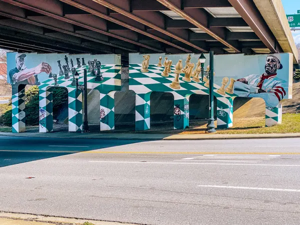 The Chess Players Murals Asheville NC with chess broad painted under highway bridge