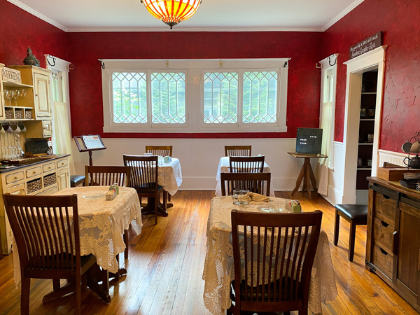 The Inn Around The Corner Bed and Breakfast with kitchen with red and white walls and tables and chairs