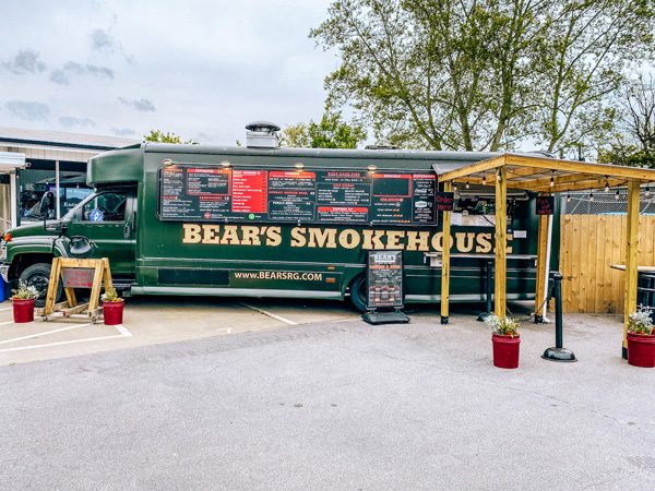 Bear's Smokehouse Asheville NC permanent food truck in parking lot with restaurant behind it