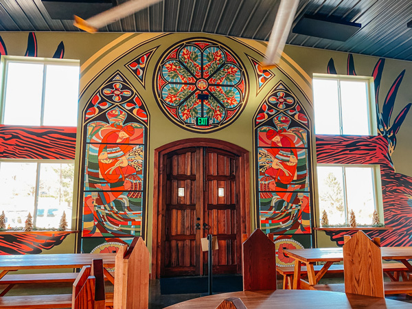 Burning Blush Brewery Taproom with Victorian era seating and murals