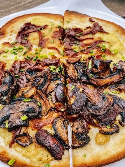 Grata Pizzeria UpCountry Brewing West Asheville sliced pizza with mushrooms