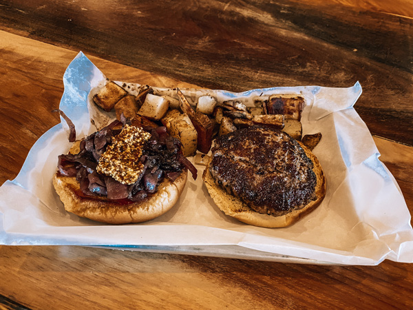 The Burger Barn Parker Binns Vineyards with open faced burger with onions and potatoes