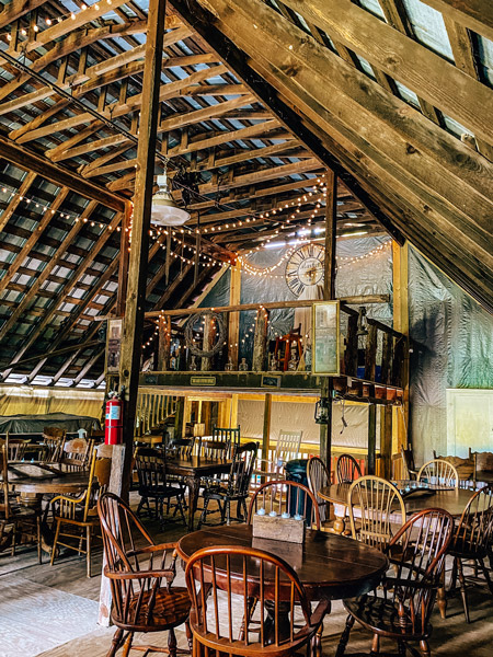 Baker Buffalo Creek Vineyard Winery Barn on second story with lights, tables, and chairs