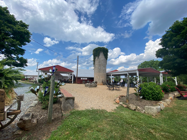 Baker Buffalo Creek Vineyard and Winery Near Asheville NC with silo, winery patio, and blue cloudy sky