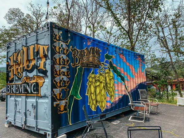 Lookout Brewing Company with chairs, urban art with local and hops on container