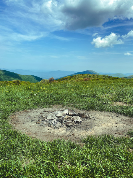 Max Patch Loop Summit Hike with fire pit, green grass, and mountains