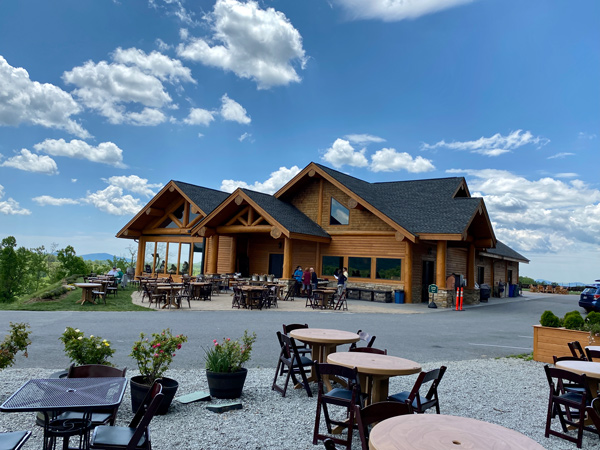 Point Lookout Vineyards Near Asheville NC with tasting room, outdoor tables and seating, and paved road